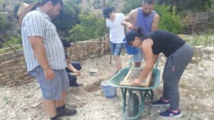 Architecture students learning how to make adobe bricks from the soil they stood on to build a new classroom build a new